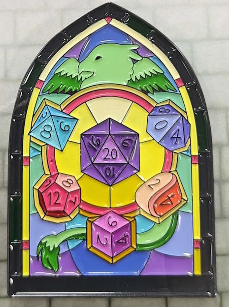 Soft enamel of a black-rimmed stained glass arched window depicting a green Griffin head, wings & tail and 6 of the 7 traditional shapes in a polyhedral dice set in a beautiful multicolored leaded window, reminiscent of the stained glass windows in cathedrals and castles in the U.K.